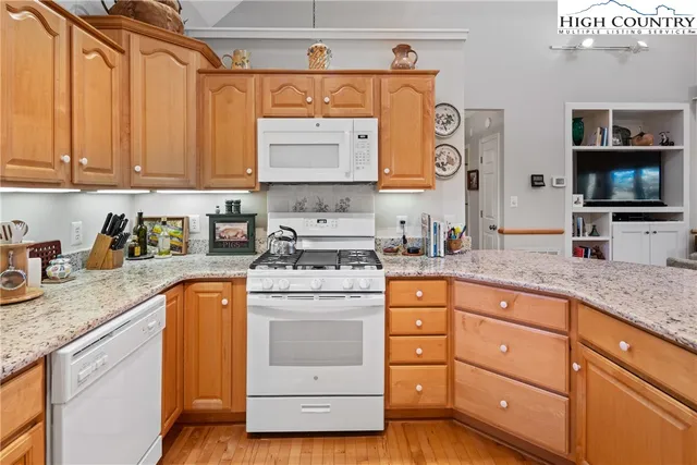 a kitchen with granite countertop a sink and a stove top oven