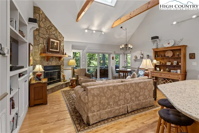 a living room with fireplace furniture and a flat screen tv