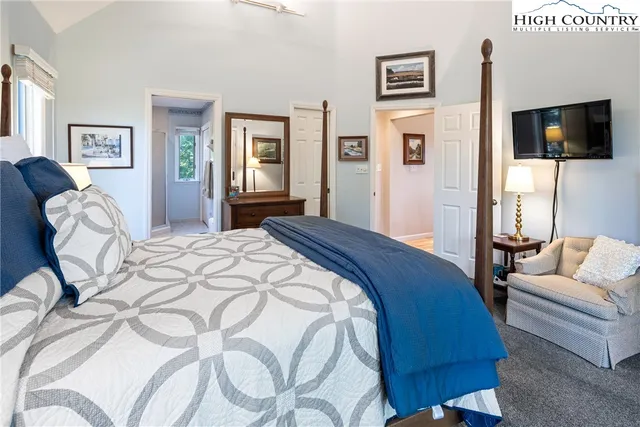 a bedroom with a bed a couch and dresser