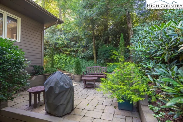 a view of backyard with outdoor seating and green space