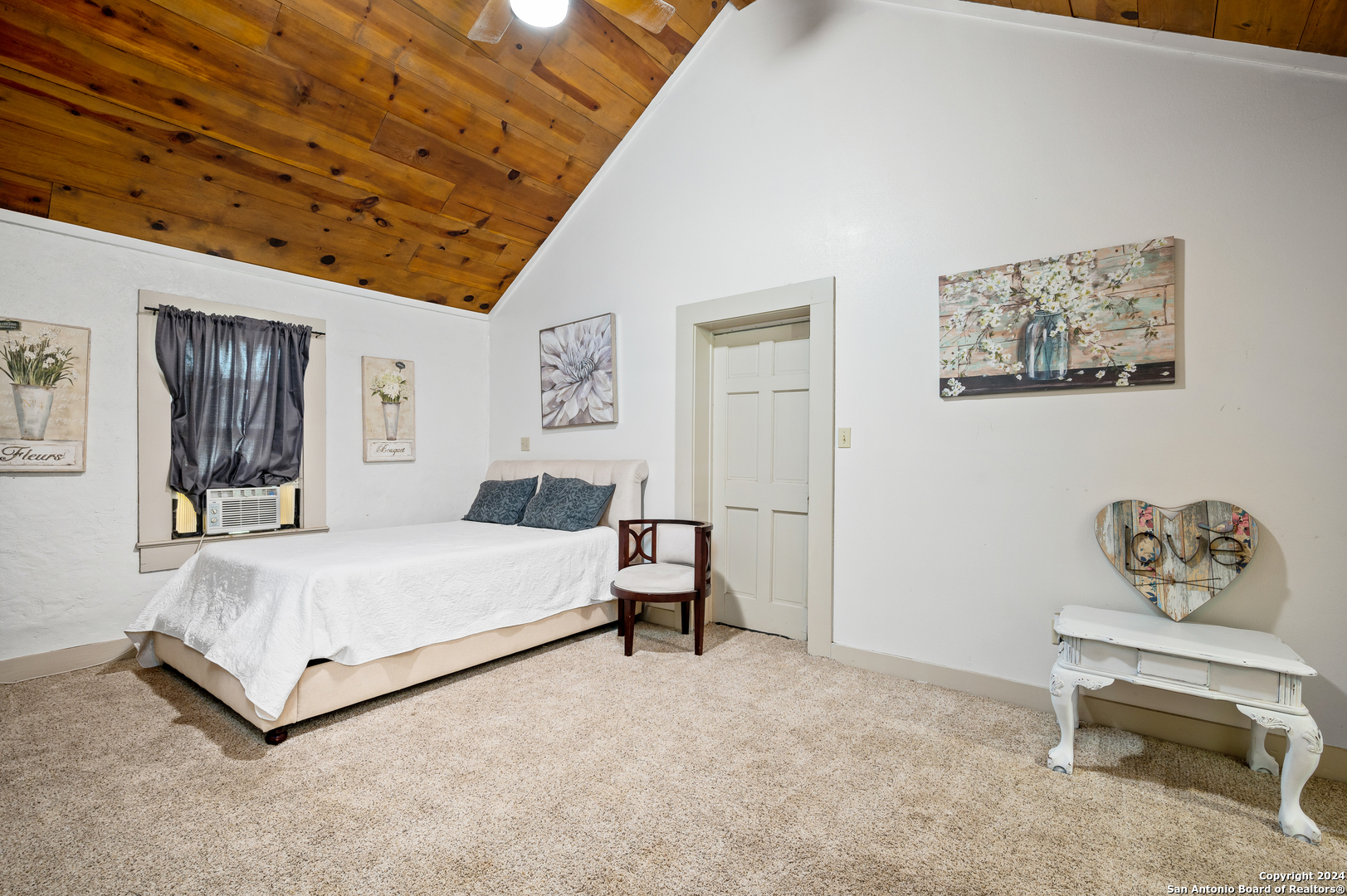 109 Waring Welfare Road Boerne, TX 78006 - Photo 14 of 21 a bedroom with a bed and a table in it