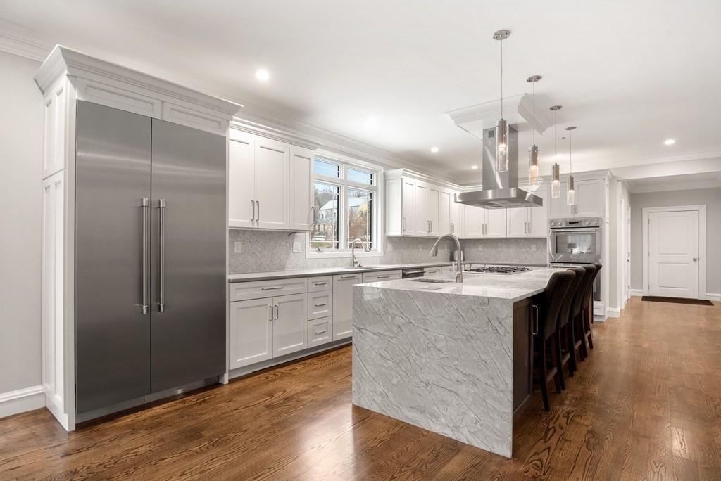 6 West Knoll Road Andover, MA 01810 - Photo 13 of 42 a large kitchen with stainless steel appliances granite countertop a sink a counter space and wooden floor