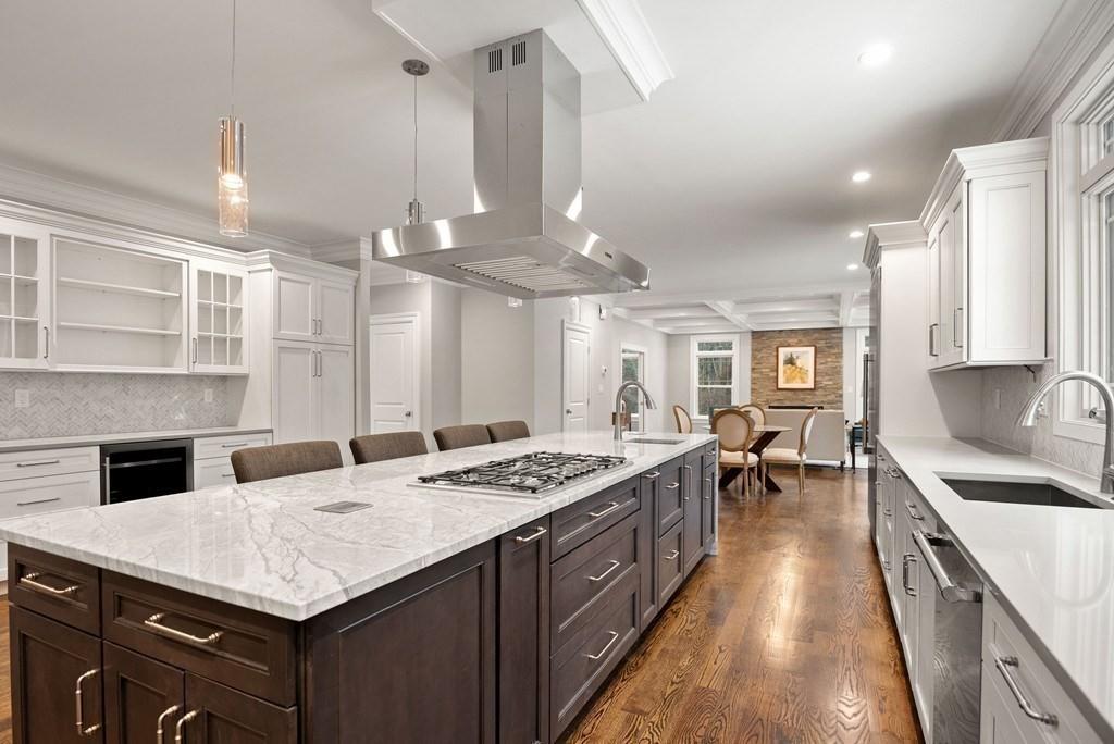6 West Knoll Road Andover, MA 01810 - Photo 15 of 42 a kitchen with stainless steel appliances kitchen island granite countertop a sink stove and cabinets