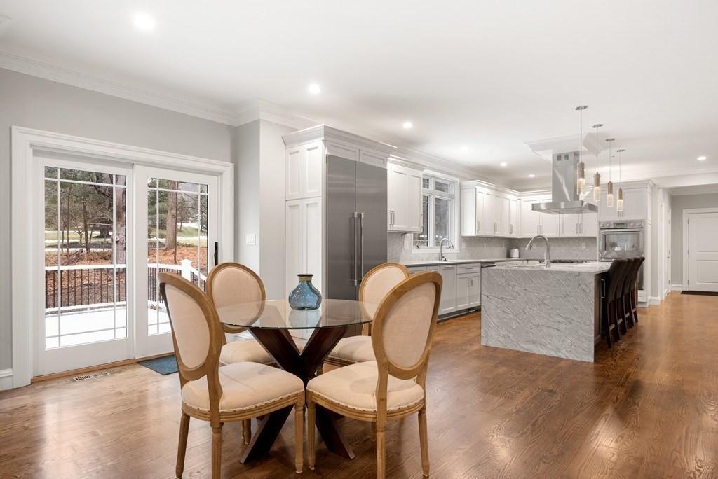 6 West Knoll Road Andover, MA 01810 - Photo 22 of 42 a dining room with kitchen island furniture a sink and kitchen view
