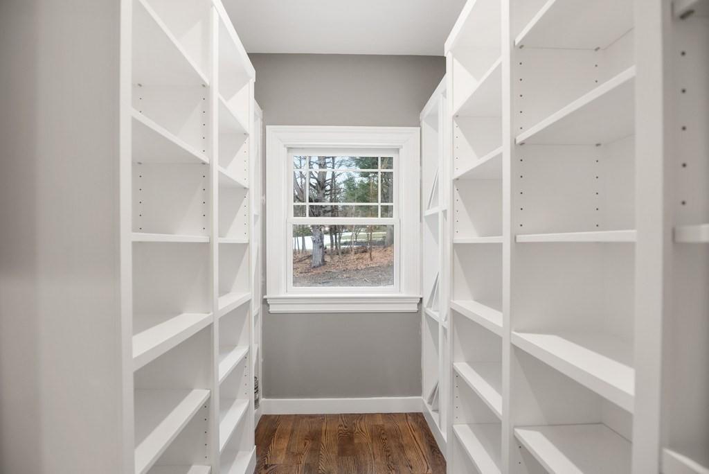 6 West Knoll Road Andover, MA 01810 - Photo 23 of 42 a view of an empty walk in closet with wooden floor and a window