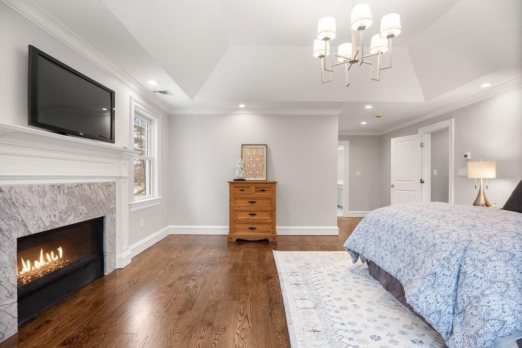 6 West Knoll Road Andover, MA 01810 - Photo 30 of 42 a spacious bedroom with a bed and a fireplace