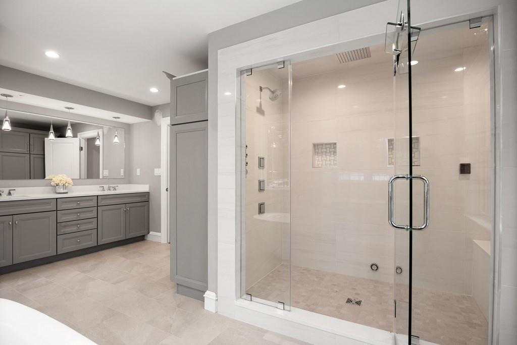 6 West Knoll Road Andover, MA 01810 - Photo 34 of 42 a bathroom with a granite countertop sink a mirror a glass door a glass door shower and a mirror