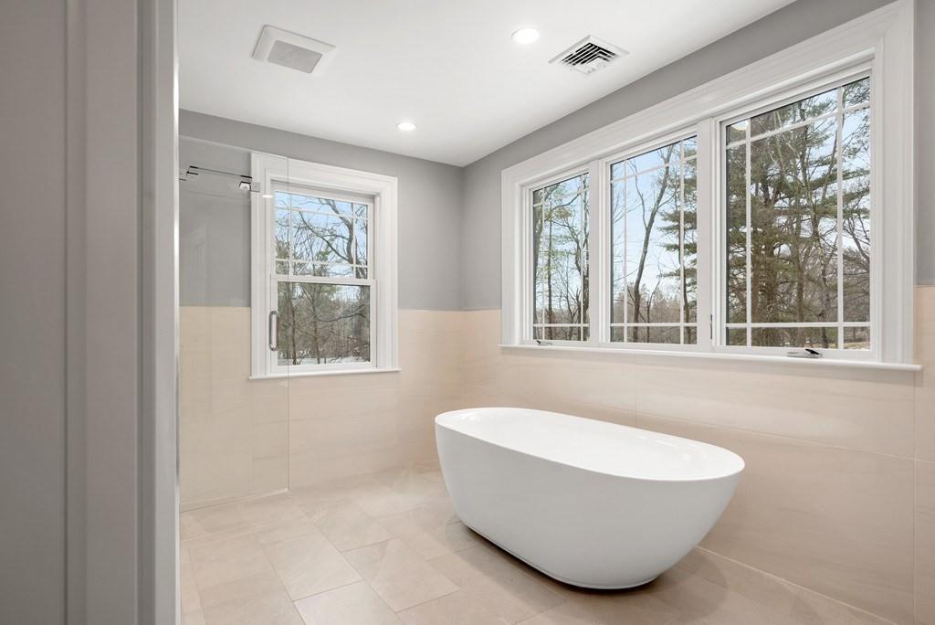 6 West Knoll Road Andover, MA 01810 - Photo 35 of 42 a white bath tub sitting in a spacious bathroom next to a window