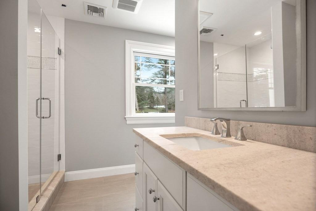 6 West Knoll Road Andover, MA 01810 - Photo 39 of 42 a bathroom with a granite countertop sink and a mirror