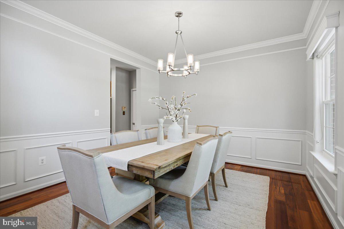 2424 Springbrook Court Huntingtown, MD 20639 - Photo 15 of 103 a dining room with furniture a chandelier and wooden floor