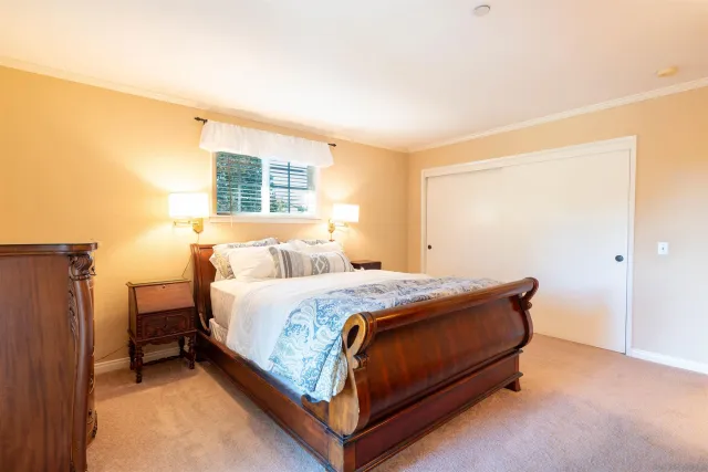 a bed sitting in a bedroom next to a window