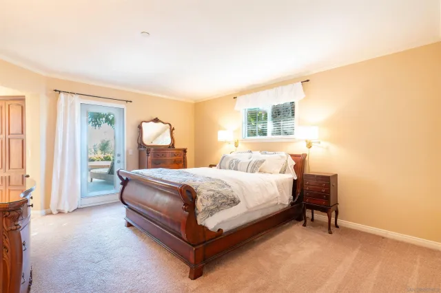 a bed sitting in a spacious bedroom next to a window