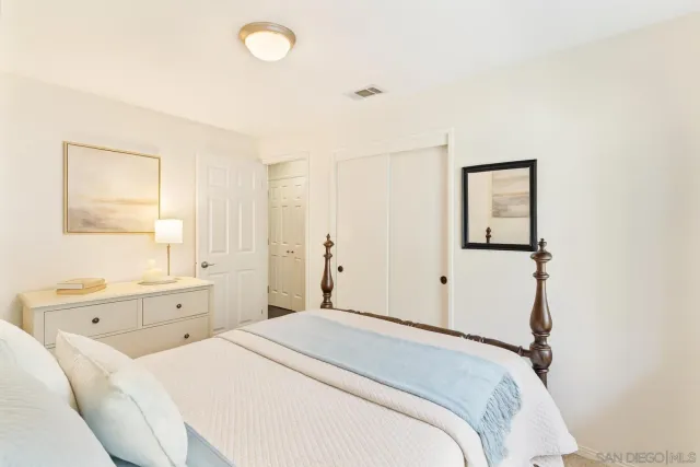 a view of patio with table and chairs under an umbrella with a barbeque