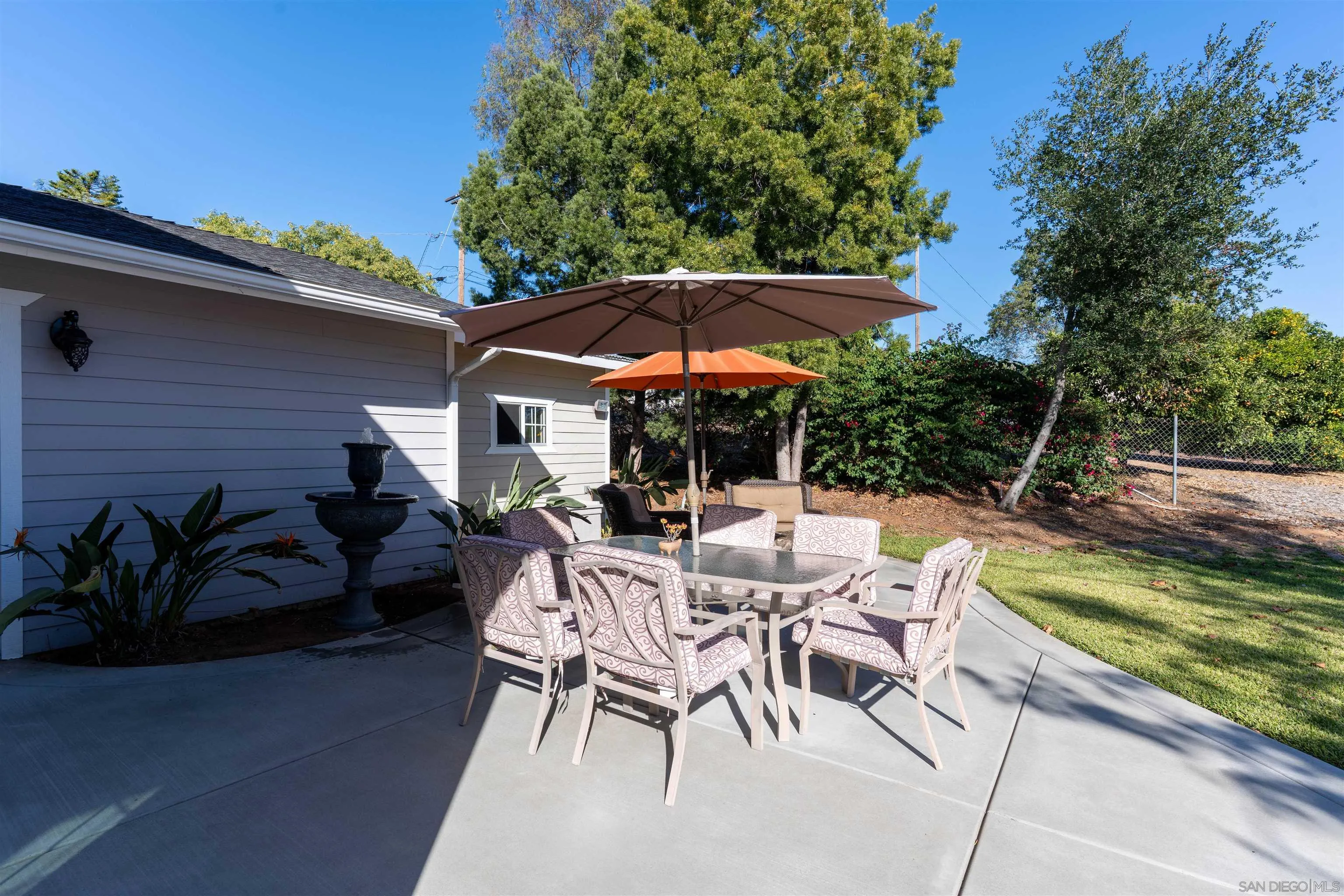 3121 Alta Verde Drive Fallbrook, CA 92028 - Photo 21 of 31 a view of patio with table and chairs under an umbrella with a barbeque