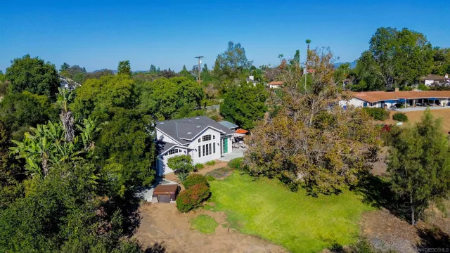 aerial view of a house with yard swimming pool and outdoor seating