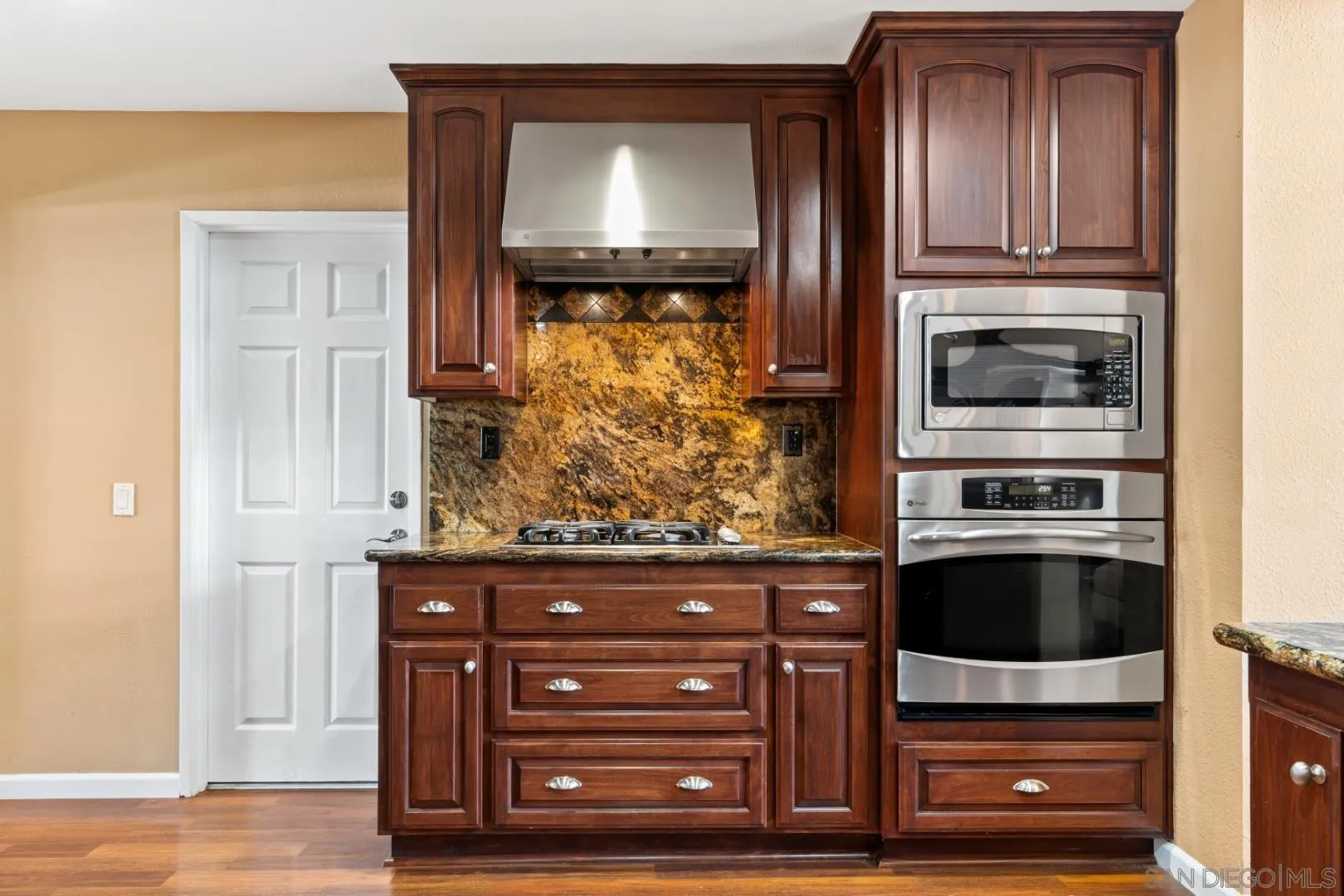 3121 Alta Verde Drive Fallbrook, CA 92028 - Photo 9 of 31 a kitchen with granite countertop a oven and a stove