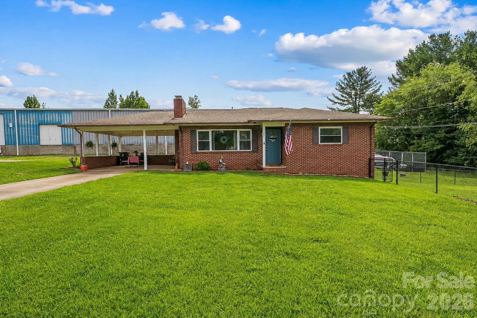 691 Central Street Hudson, NC 28638 - Photo 1 of 22 a view of a house with a yard and potted plants