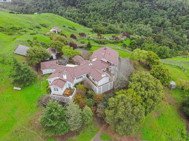 an aerial view of a house with a yard