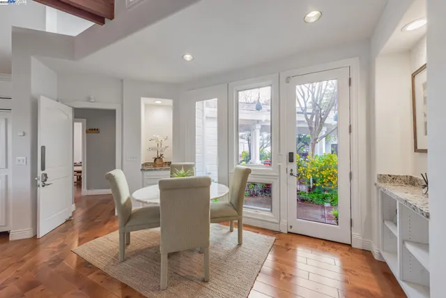 a living room with stainless steel appliances kitchen island granite countertop furniture and a fireplace