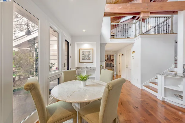 a kitchen with a table chairs stove and cabinets