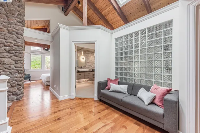 a bedroom with furniture and a wooden floor