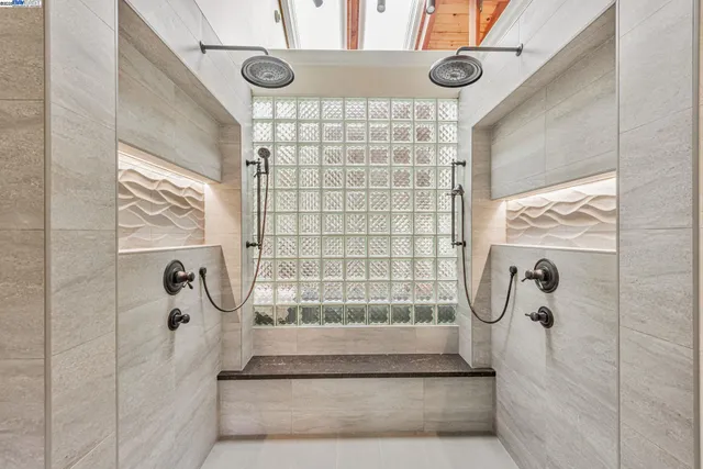 a bathroom with a granite countertop sink a mirror and shower