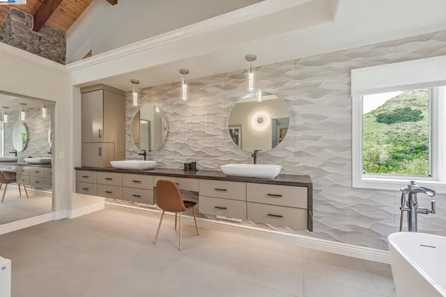 a kitchen with granite countertop white cabinets appliances and a sink