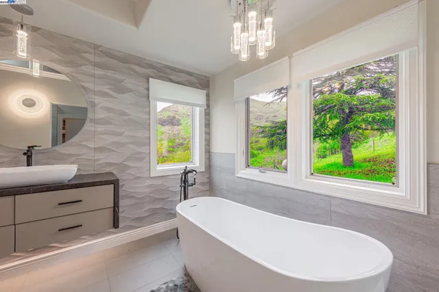 a view of a porch with furniture and a garden