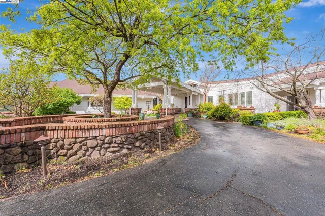 a front view of a house with garden