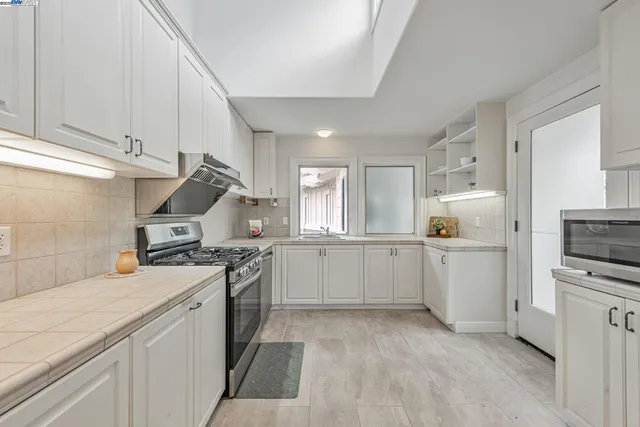 a view of a house with a backyard and garden