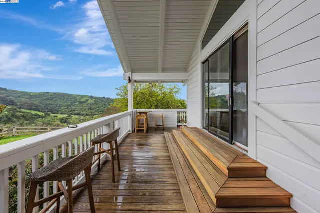 a view of a yard with wooden fence and a bench