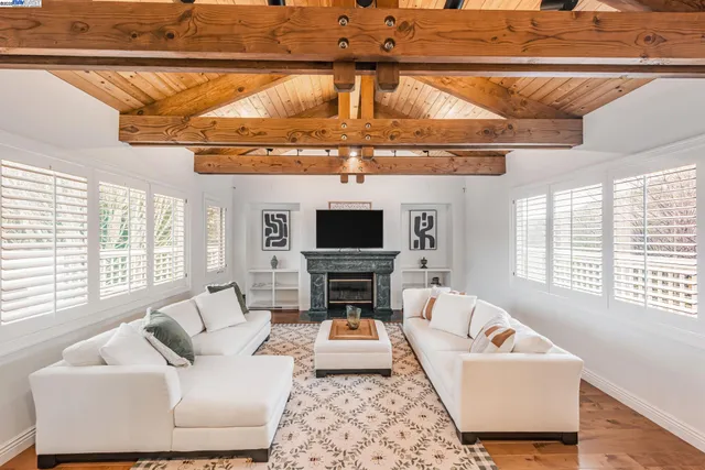 a kitchen with stainless steel appliances granite countertop a stove a sink dishwasher and a refrigerator with white cabinets