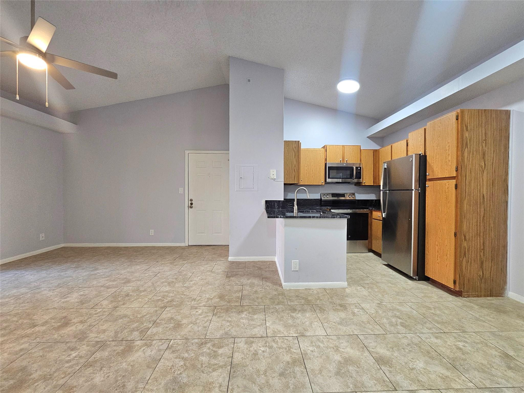 651 Lyons Road, Unit 10202 Coconut Creek, FL 33063 - Photo 1 of 28 a kitchen with granite countertop a refrigerator and a stove top oven