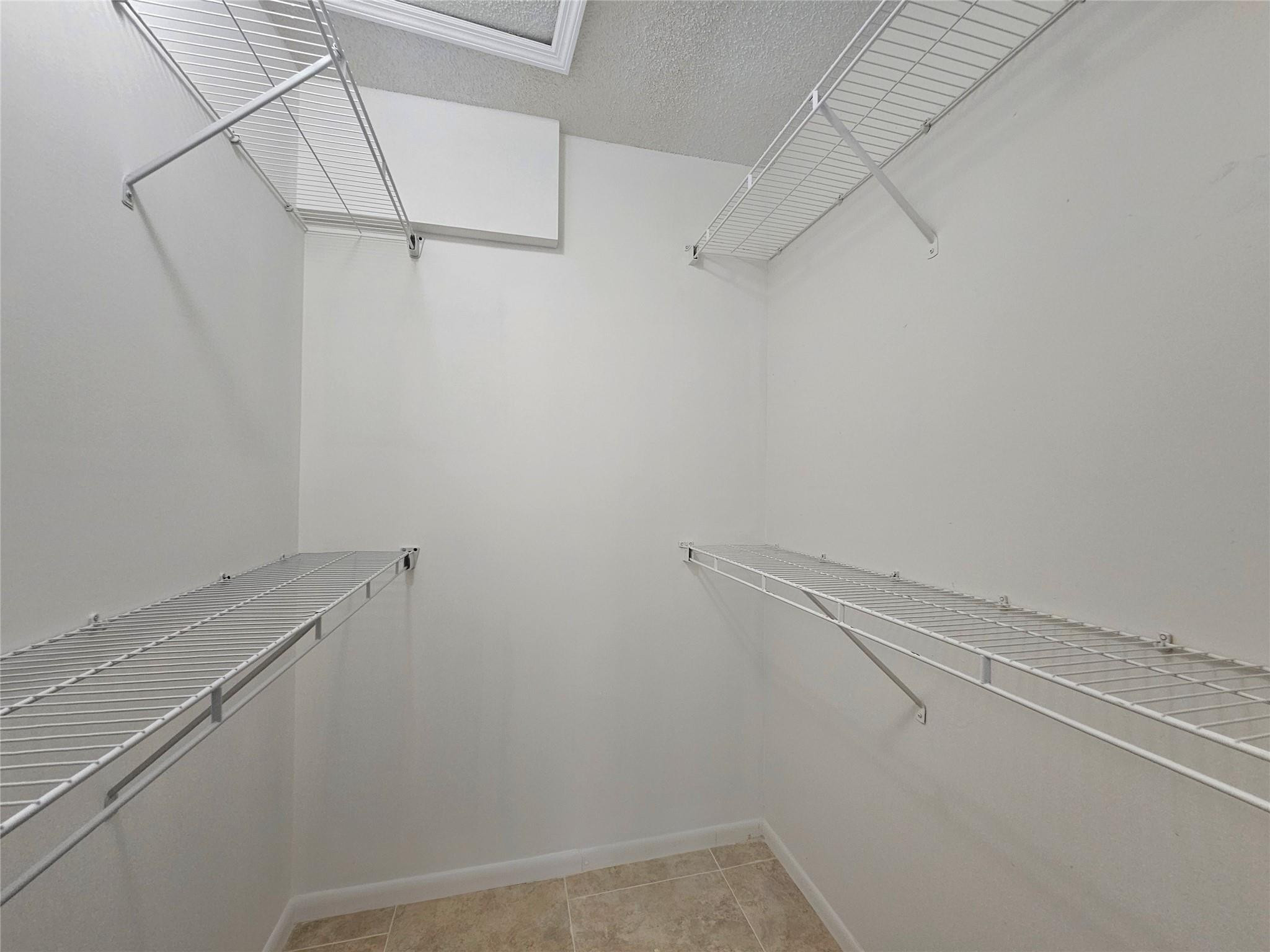 651 Lyons Road, Unit 10202 Coconut Creek, FL 33063 - Photo 11 of 28 a view of a room with racks on the wall