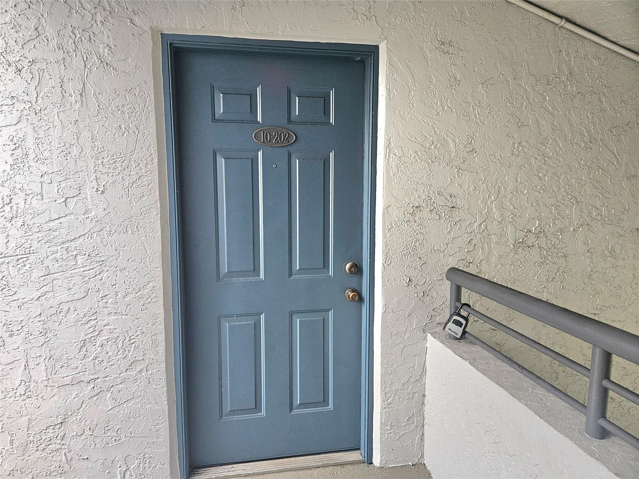 651 Lyons Road, Unit 10202 Coconut Creek, FL 33063 - Photo 13 of 28 view of wooden door