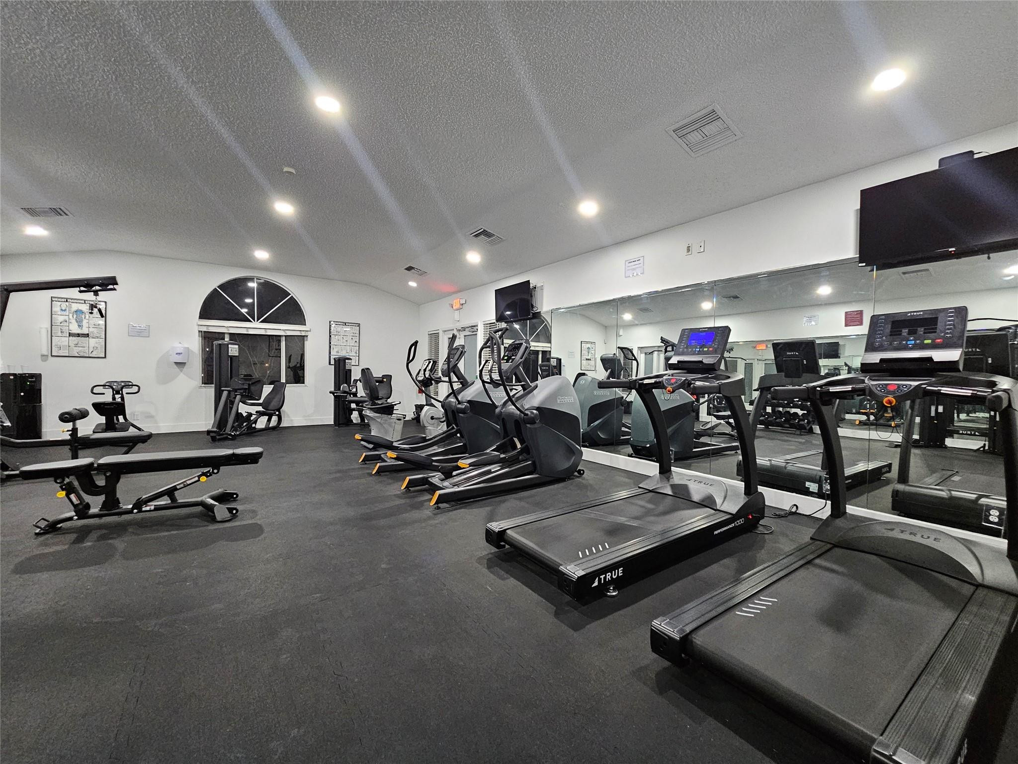 651 Lyons Road, Unit 10202 Coconut Creek, FL 33063 - Photo 19 of 28 a view of a room with gym equipment