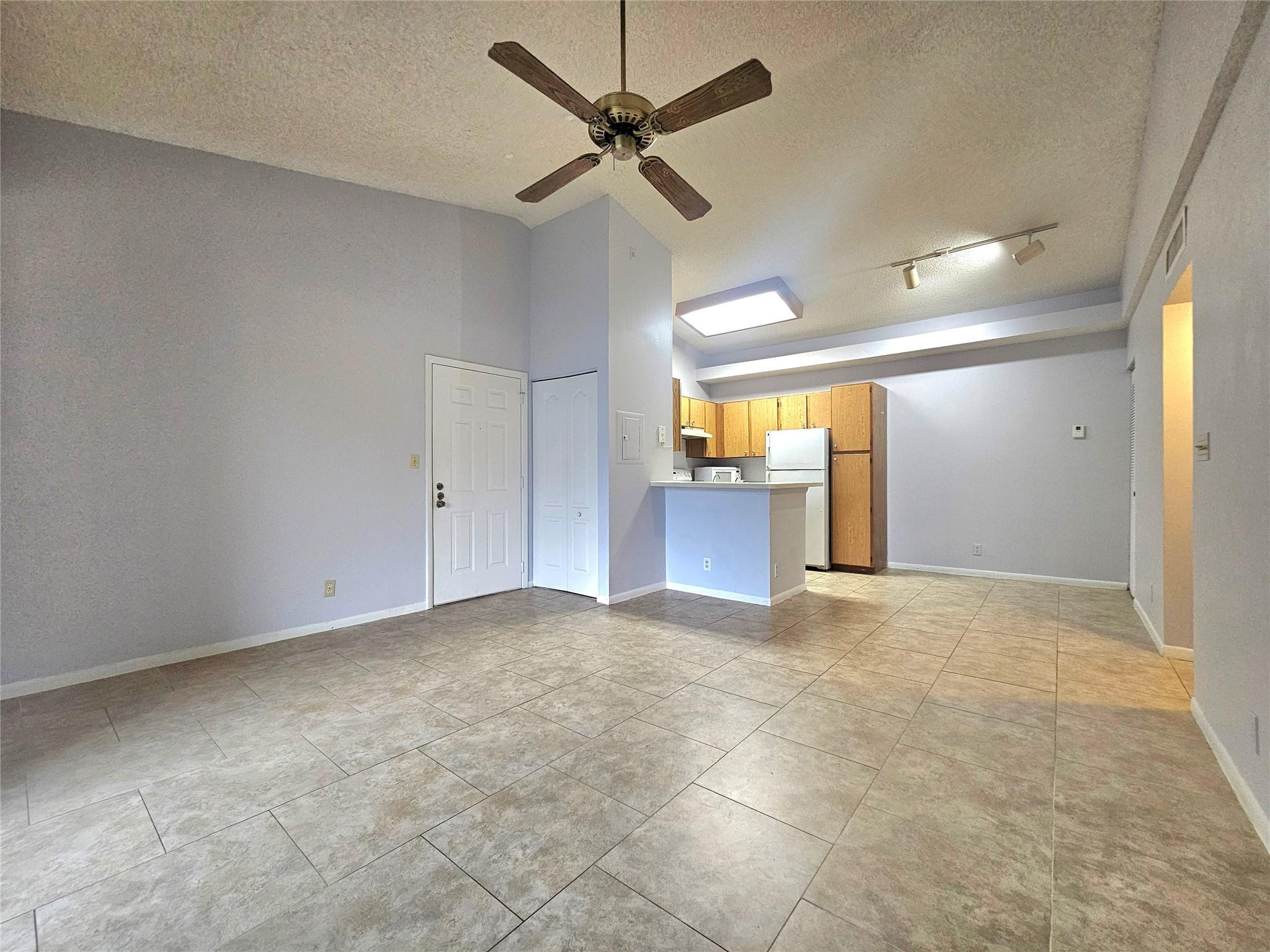651 Lyons Road, Unit 10202 Coconut Creek, FL 33063 - Photo 2 of 28 a view of empty room with a ceiling fan and window