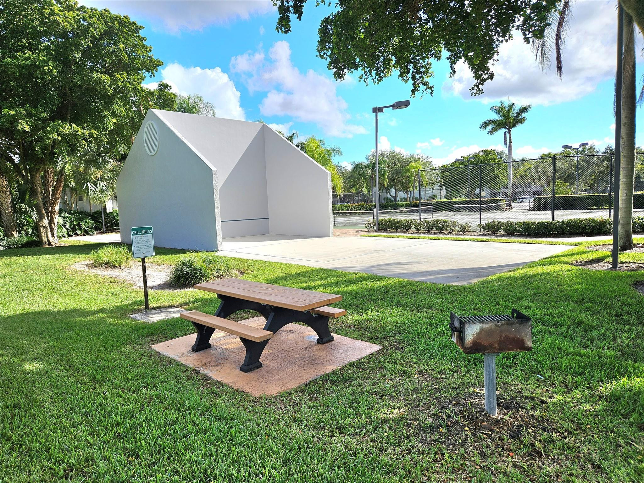 651 Lyons Road, Unit 10202 Coconut Creek, FL 33063 - Photo 23 of 28 a garden view with a seating space