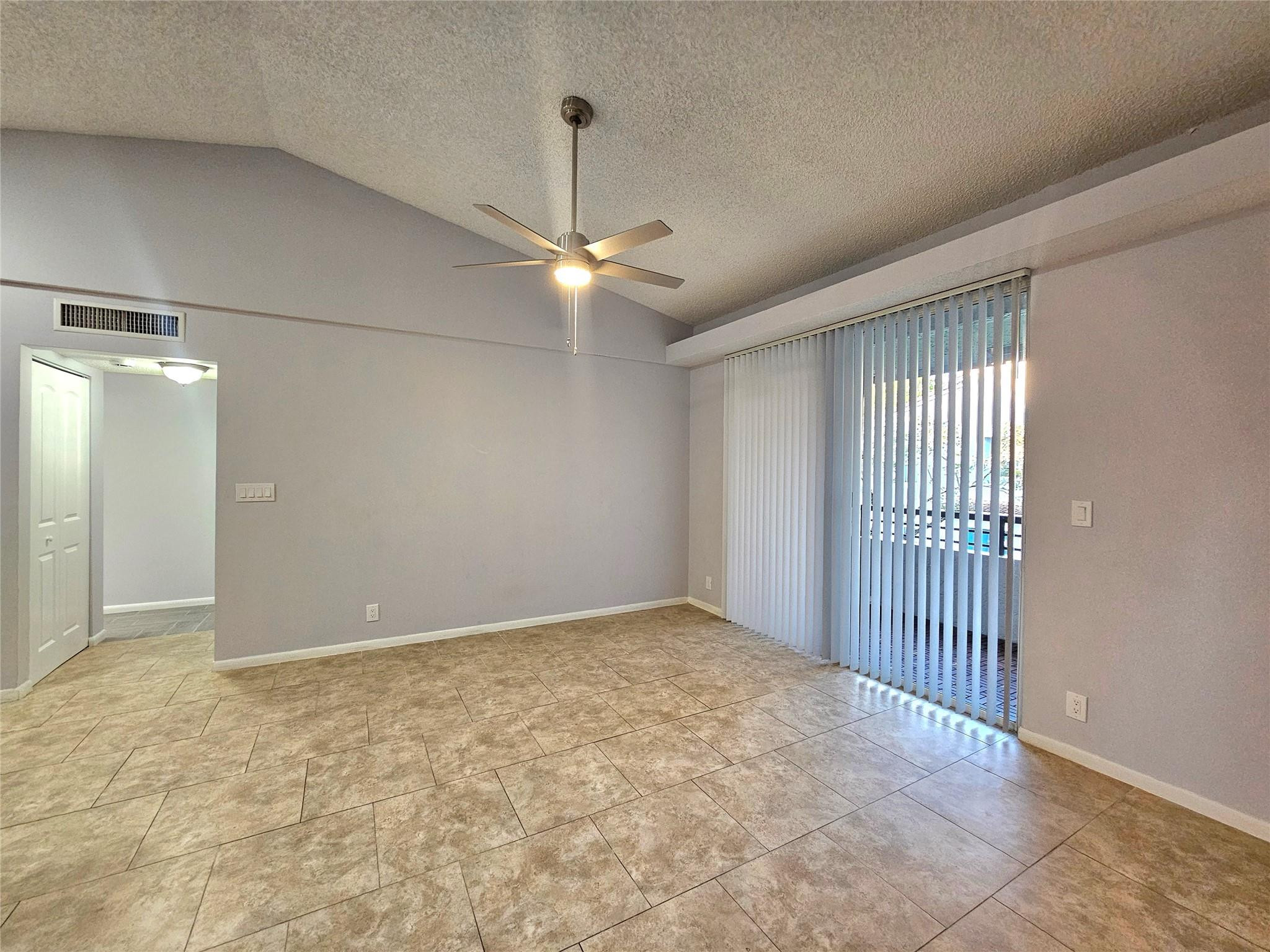 651 Lyons Road, Unit 10202 Coconut Creek, FL 33063 - Photo 3 of 28 a view of an empty room with a window