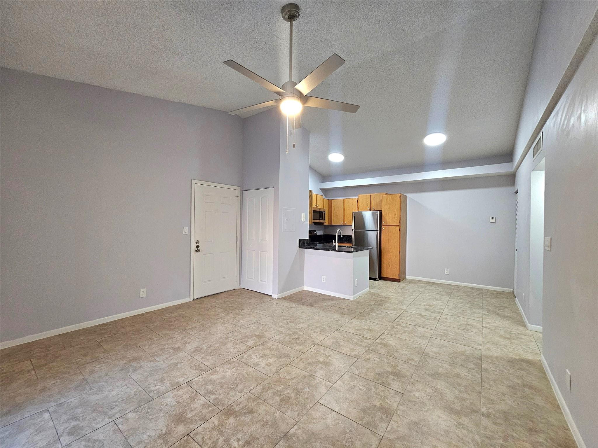 651 Lyons Road, Unit 10202 Coconut Creek, FL 33063 - Photo 4 of 28 a view of a kitchen with a sink and a refrigerator