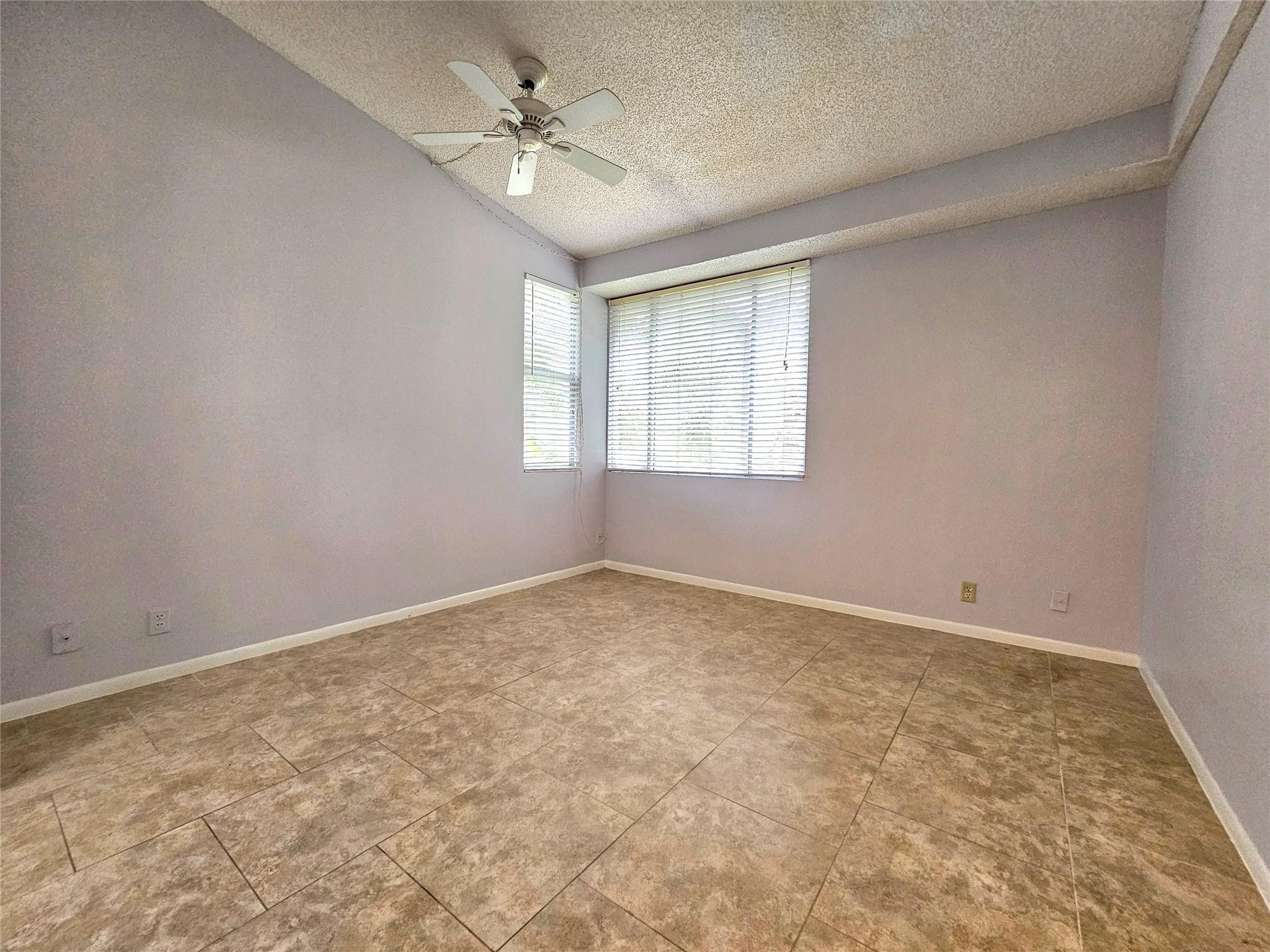 651 Lyons Road, Unit 10202 Coconut Creek, FL 33063 - Photo 10 of 28 an empty room with a window