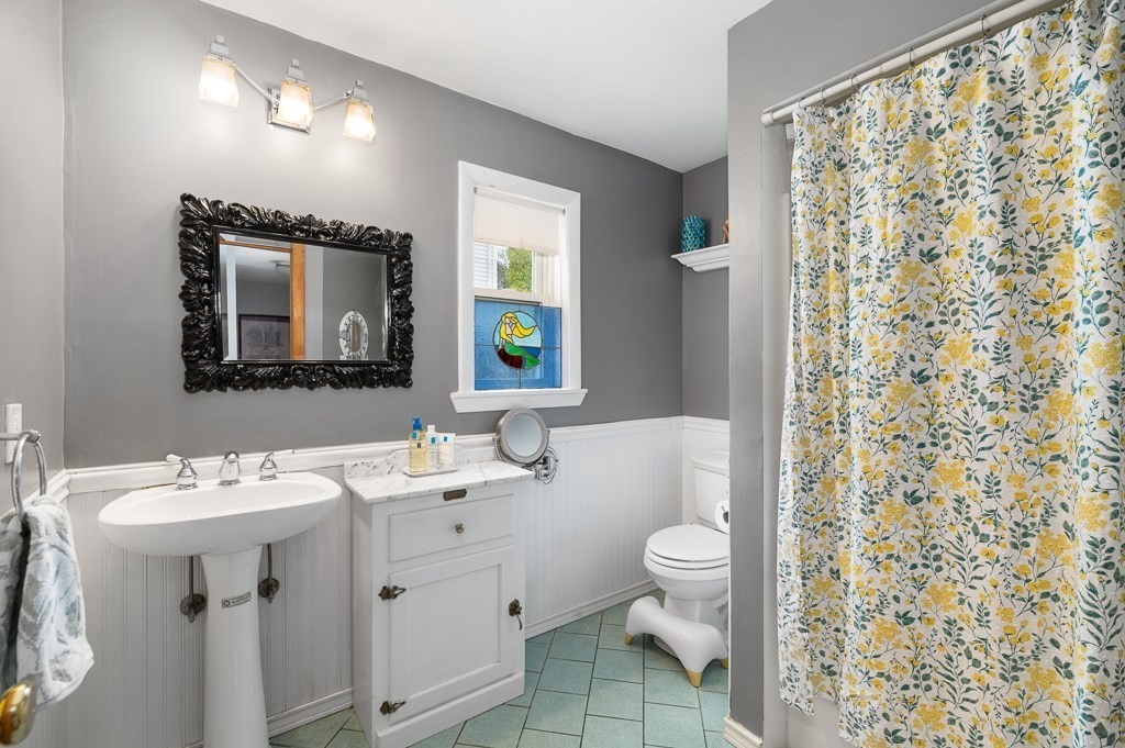 9 Alpine Court Gloucester, MA 01930 - Photo 15 of 32 a bathroom with a sink a toilet and a mirror