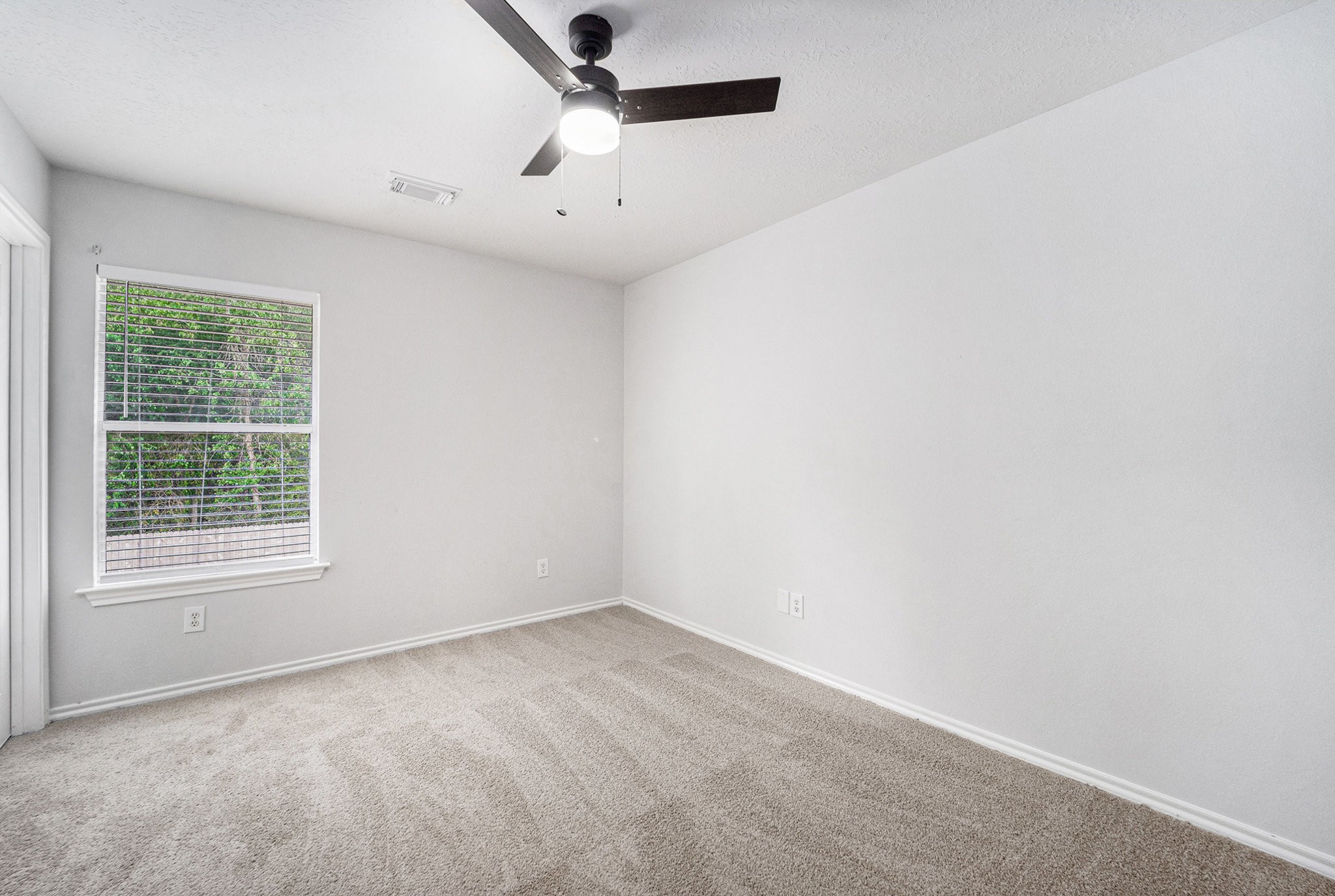 18131 Stone Trail Manor Drive Humble, TX 77346 - Photo 21 of 31 an empty room with a window