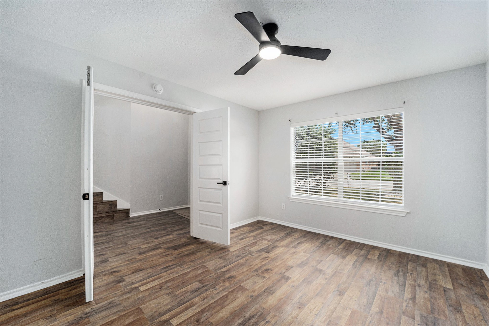 18131 Stone Trail Manor Drive Humble, TX 77346 - Photo 8 of 31 an empty room with wooden floor and windows