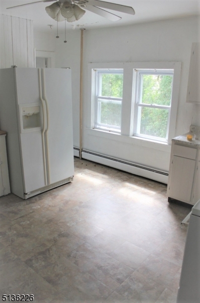28 Mohawk Avenue, Unit 2 Sparta, NJ 07871 - Photo 2 of 4 an empty room with windows and refrigerator