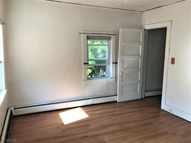 28 Mohawk Avenue, Unit 2 Sparta, NJ 07871 - Photo 4 of 4 an empty room with wooden floor and windows