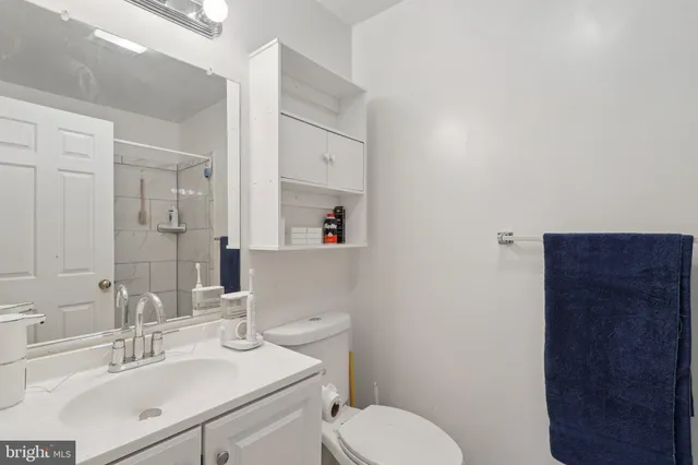 a bathroom with a sink a toilet and vanity