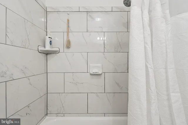 a bathroom with a sink toilet vanity and shower