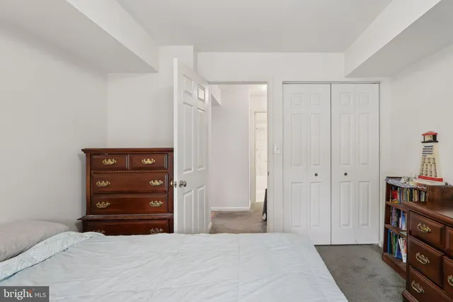a view of a white house and a large tree in front of a house