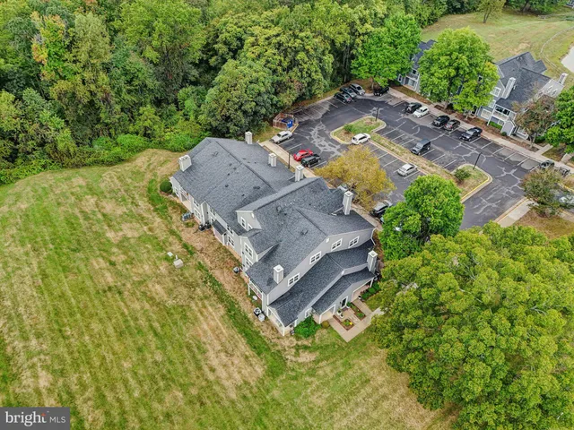 an aerial view of a house with pool a yard and outdoor seating